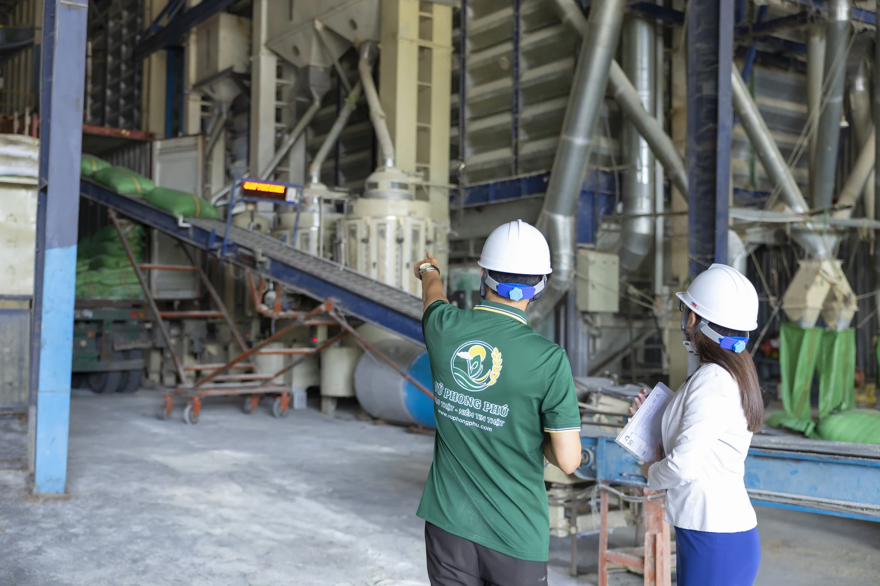 Reviewing processing equipment at the factory.